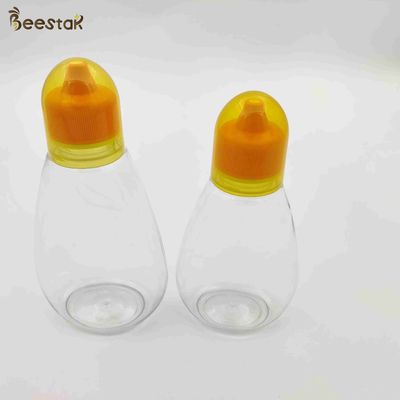 comprar 250ml 350ml 500ml Honey Jar And Spoon Plastic Honey Bottles vacío para el almacenamiento de la miel fabricación en línea